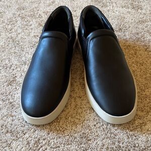 Vince brand new black leather slip ons with white sole.